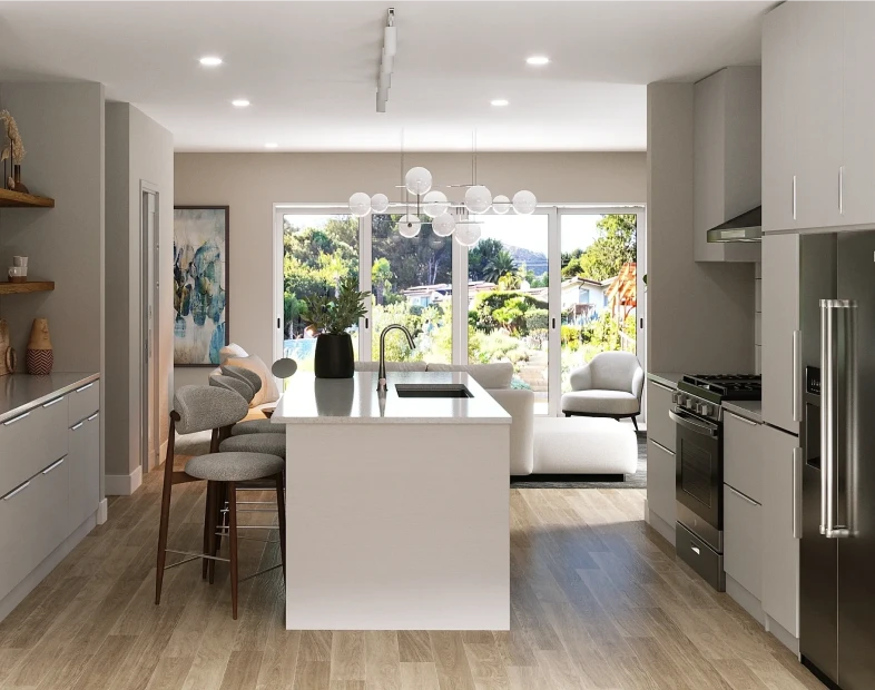 Modern kitchen with a central island, bar stools, stainless steel appliances, and large windows providing natural light and garden views—perfect for stylish modular homes.